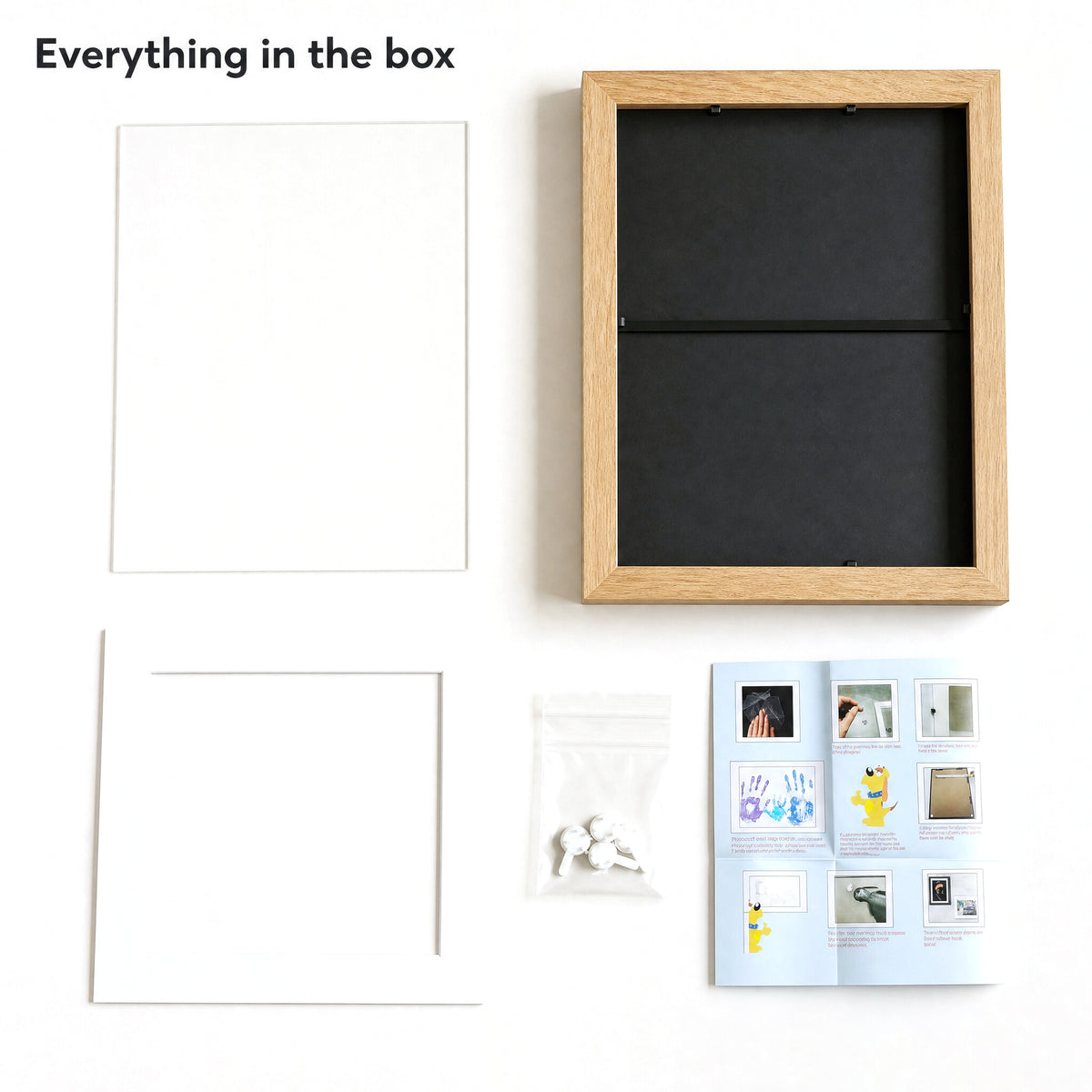 Everything in the box: frame, clear acrylic front, white bevelled mat, traceless hooks, instructions