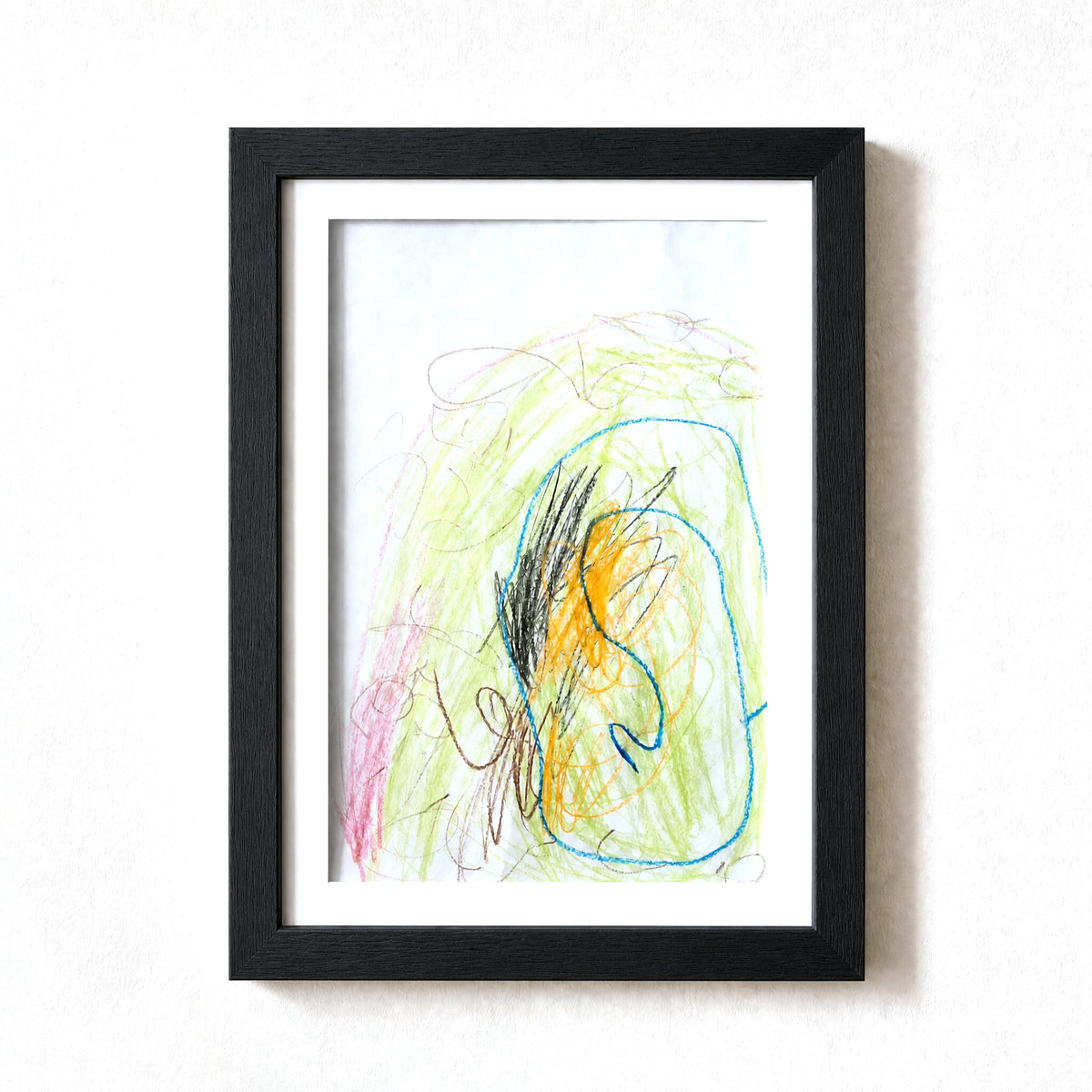 PeekDoodle art frame in black on a wall, holding a child's crayon drawing